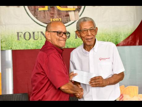 
Melbourne Cricket Club President Mark Neita (left) hands over a cheque to Special Olympics Jamaica Executive Director, Roy Howell, during a presentation ceremony at the club on Friday. 