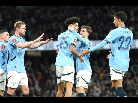 
Manchester City players celebrate after Nico O’Reilly (centre) scored his side’s opening goal during the English FA Cup football match against Plymouth Argyle at Etihad Stadium, Manchester, England yesterday.