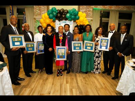 Gary Williams (centre), founder and chairman of Children of Jamaica Outreach (COJO), with Audrey Marks (fourth left), Jamaica’s ambassador to the United States (US); Nick Perry (right), the former US ambassador to Jamaica; and honourees at COJO’s 3Oth 