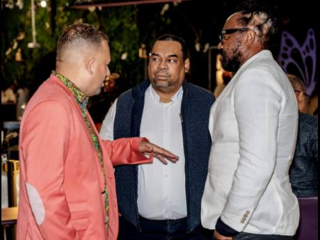At left, consul general for Jamaica in Miami, Oliver Mair, makes a point to Gary Peart, executive chairman Supreme Ventures Limited (centre), and Tony Rebel, at the launch of Rebel Salute at Kekoon Restaurant Davie Florida on Sunday.