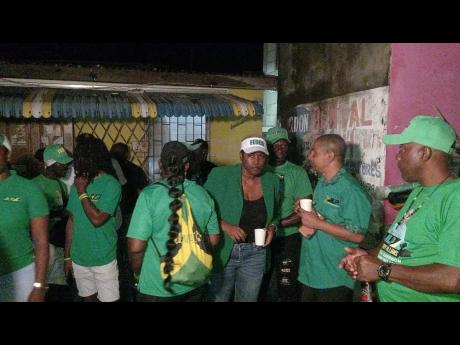 Jamaica Labour Party candidate for Clarendon Central Delroy Williams (holding cup, second right) at a welcome party in the constituency on March 6.