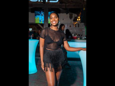 Television host Mandy Cowan makes a statement in a sheer black top and black fringe skirt. 