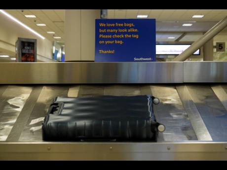 Southwest Airlines signage is displayed at baggage claim at Midway International Airport, Tuesday, March 11, 2025, in Chicago.