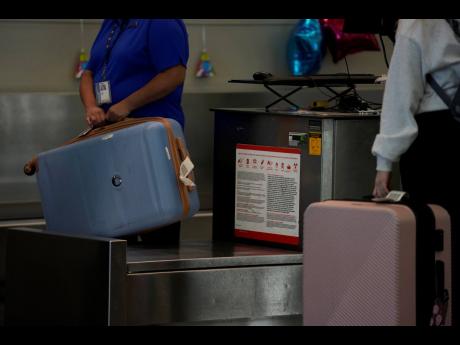 A Southwest Airlines traveller checks a bag at Midway International Airport, Tuesday, March 11, 2025, in Chicago.