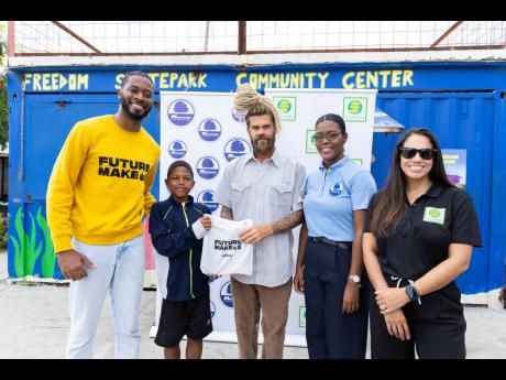 Vanessa Nelson (second right), project and programme coordinator, Musson Foundation, and Lisa D’Oyen (right), executive director, Seprod Foundation, pause for a photo op with ‘Future Makers’ author, Joel Nomdarkham (left); Park Manager, Freedom Skate