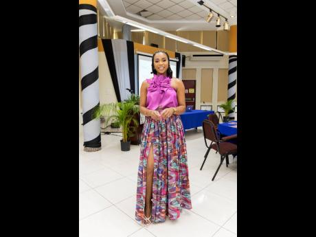 Head woman in charge, Krystal Tomlinson, takes a moment to smile for the camera, donning a statement purple top with a maxi front split skirt.