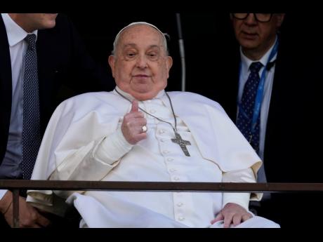 Pope Francis thumbs up as he appears at a window of the Agostino Gemelli Polyclinic in Rome on March 23, 2025, where he has been treated for bronchitis and bilateral pneumonia since February 14, 2025.
