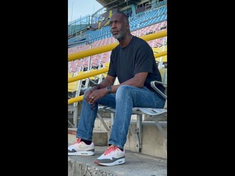 United States’ track legend Michael Johnson takes a look at the completion of resurfacing activities on the National Stadium track on Tuesday. 