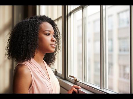 Representational image of a young woman looking out of a window. Kristen Gyles writes: Did those pre-historic people from the year 2000 consider that house prices could grow tenfold in 25 years? Did they even think about it?