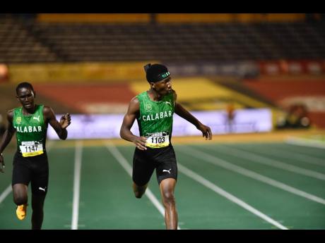 Calabar High’s  Rajeve Allison (right) wins the Class Three 400 metres final in 50.33 seconds ahead of teammate Justin McKoy, 50.66, at the 2025 ISSA GraceKennedy Boys and Girls’ Athletics Championships at the National Stadium last night. 