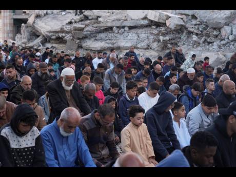 Palestinians attend Eid al-Fitr prayer in Deir al-Balah, Gaza Strip.