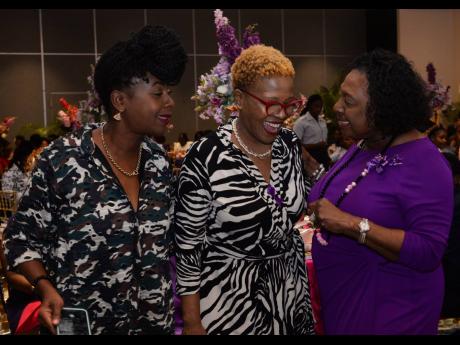 Minister of Culture, Gender, Entertainment and Sport, Olivia Grange (right), has a light moment with Professor of Culture, Gender and Society at The University of the West Indies (UWI), Donna P. Hope (centre), and youth advocate, Emprezz Golding, during th