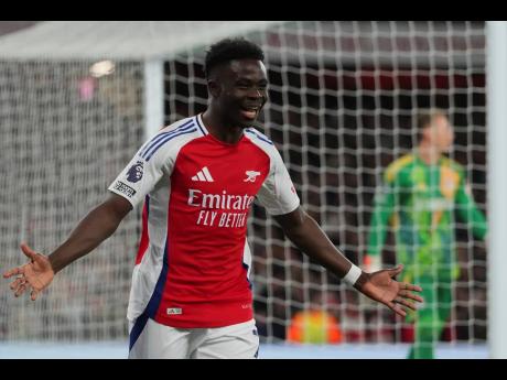 Arsenal’s Bukayo Saka celebrates after scoring his side’s second goal during the English Premier League football match against Fulham at Emirates Stadium in London yesterday.