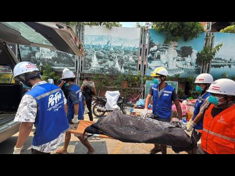 Rescuers carry the body of a victim, from a collapsed building, in the aftermath of Friday's earthquake in Mandalay, Myanmar, Thursday, April 3, 2025. (AP Photo)