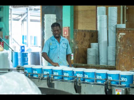 An unnamed worker handles Berger 303 point at the Berger Paints Jamaica factory, Spanish Town Road, Kingston.