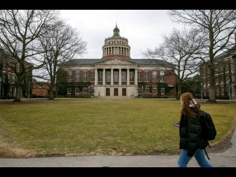 A student walks by the Rush Rhees Library at the University of Rochester, February 22, 2023. (AP Photo/Ted Shaffrey, File)