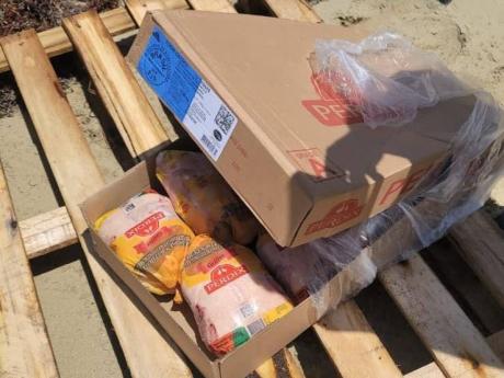 Chicken from a container that washed ashore along the Hellshire coastline in St Catherine.