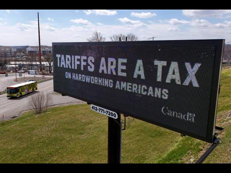 Credit: AP A digital billboard flashes a tariffs message in Kennedy Township, Pennsylvania, Tuesday, March 25, 2025.