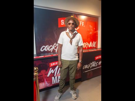 Chef Jerron Green pairs a crisp textured white shirt with olive-green pants and accessorised with a fedora, printed scarf, and gold accents in an ode to laid-back European style.