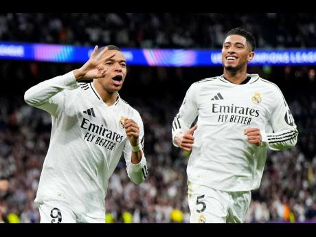 Real Madrid’s Kylian Mbappe celebrates with Jude Bellingham (right) after scoring his side’s third goal during the Champions League play-off second-leg match against Manchester City at the Santiago Bernabeu Stadium in Madrid, Spain, on February 19.