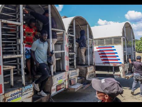 Haitians deported from the Dominican Republic get out of trucks in Carrizal, Dominican Republic, on the border with Haiti, Thursday, January 30, 2025. (AP Photo/Martin Adames)