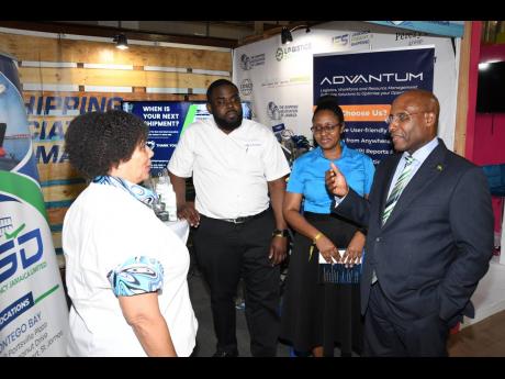 EXPO JAMAICA: President of The Shipping Association of Jamaica, Corah Ann Robertson-Sylvester (left), welcomes Minister of Industry, Investment and Commerce, Senator Aubyn Hill (right), to the organisation’s booth at Expo Jamaica 2025 last Wednesday. Pic