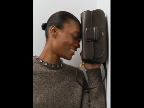 Clutching the Oroton Carter baguette, a radiant Depass wears the Nep jewelled crewneck.
