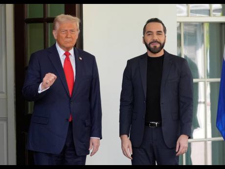 President Donald Trump, left, gestures as he greets El Salvador's President Nayib Bukele as Bukele arrives at the White House, Monday, April 14, 2025, in Washington. (AP Photo/Manuel Balce Ceneta)
