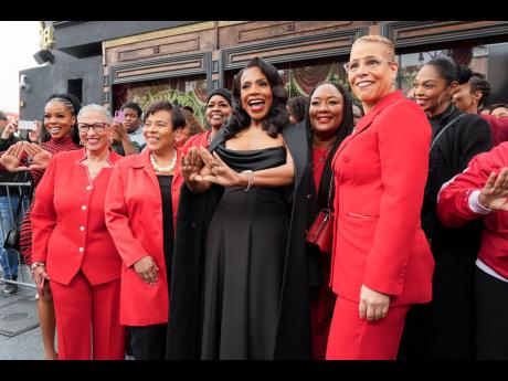 Sheryl Lee Ralph makes a delta sign with her hands as she poses with members of her sorority, Delta Sigma Theta.
