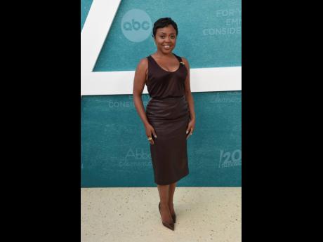 Series creator and star Quinta Brunson shows off her keen sense of style in a chocolate pencil skirt and matching tank and pumps. 