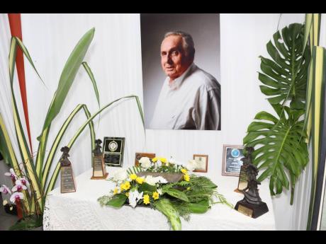 A portrait of late actor Munair Zacca hangs above the urn containing his ashes at the Cultural Tribute and Memorial Service celebrating his life and work.