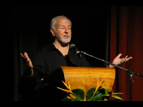 Paul Issa reads the tribute by Lennie Little-White at the Cultural Tribute and Memorial Service for Munair Zacca held on Wednesday at the Little Theatre. 