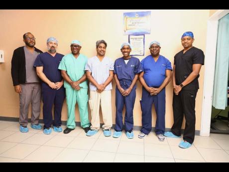 The Lumbar Disc Replacement surgical team from left are Dr Jason Toppin as the anaesthetist; Corey Harbold, a United States-based medical representative; Dr. J. Geoffrey Liburd, chief of neurosurgery at AMH; Dr Cherian Cherian, general surgeon; Dr Andy Red