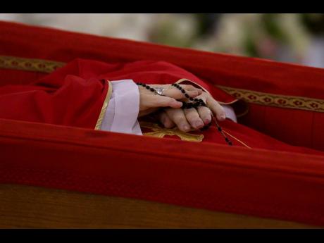 Pope Francis's body is laid out in state inside his private chapel at the Vatican, Monday, April 21, 2025. (Vatican Media via AP, HO)