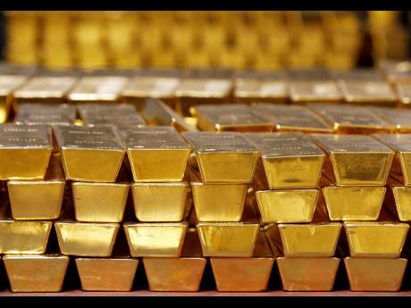 In this July 22, 2014 photo, gold bars are stacked in a vault at the United States Mint, in West Point, New York.