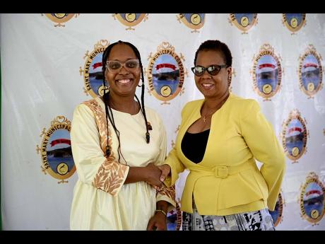 Guest speaker at the National Chief Takyi Day celebration, Associate Professor of Divinity and Religious Studies at Yale University, Dr Todne Thomas (left), is greeted by Chief Executive Officer of the St Mary Municipal Corporation, Ethlyn Douglas, at the 