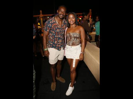 Retired Jamaican sprinter Nesta Carter and Shanice Mitchell, brand activator, Campari, smile for the camera.