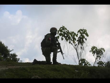FILE - A soldier carries out an anti-gang operation in the Kenscoff neighbourhood of Port-au-Prince, Haiti, Feb. 3, 2025. 