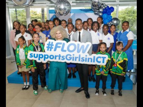 Dr Maria Myers-Hamilton, CEO of the Spectrum Management Authority, and Rhys Campbell, Executive Director of the Flow Foundation, celebrate with the recipients at Flow’s Girls in ICT Day commemorative ceremony at the company’s corporate offices on April