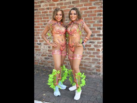 Twin sisters Shanike (left), living in Pennsylvania, and Janice Johnson, residing in Jamaica, continue their 22-year carnival tradition together. This year, they're jumping with Xodus Carnival, matching wearing Dragon Fruit costumes.




