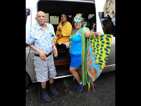Credit: Ricardo Makyn Corah Ann Robertson-Sylvester (right) made her way to watch the carnival in Jamaica Road March once again with parents 90-year-old Ishmael Robertson and 89-year-old Hermenia Robertson.