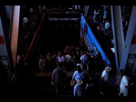 Credit: Spectators roam inside the Madrid Open tennis tournament venue during a general blackout in Madrid, Monday, April 28, 2025. (AP Photo/Manu Fernandez)
