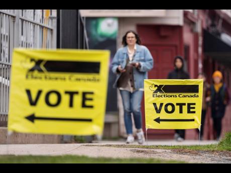 Elections Canada signage is seen as voters arrive at a polling station on Election Day in Halifax, Canada, Monday, April 28.
