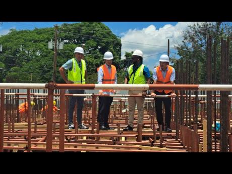 Dr Christopher Tufton (left), minister of health and wellness, and his team during a tour yesterday of the site of the new Spanish Town Hospital, currently under construction, in St Catherine.