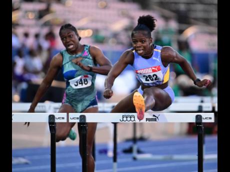 Credit: Gladstone Taylor Megan Tapper (right) clears the final hurdle ahead of Yanique Thompson in the women’s 100m hurdles finals at the JAAA National Senior and Junior Championship held at the National Stadium in St Andrew on Sunday, July 9, 2023.