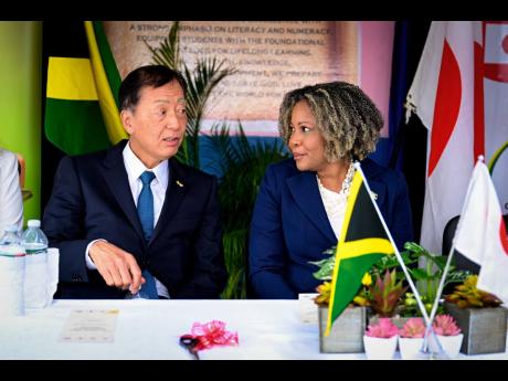 Credit: JIS Minister of Education, Skills, Youth and Information Senator Dr. Dana Morris Dixon conversing with Japan’s ambassador to Jamaica, Yasuhiro Atsumi, during Tuesday’s handover ceremony for a brand-new 29-seater Coaster bus donated to Richmond Primary an