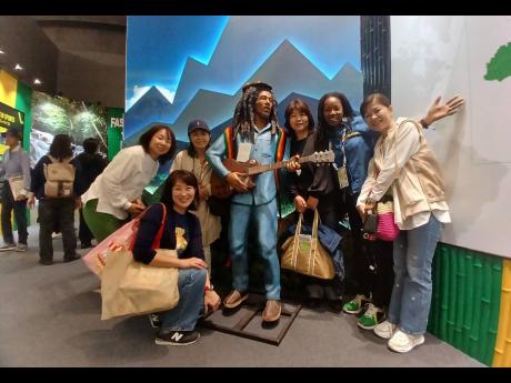 Credit: Contributed Photos Commissioner General of Section, Jamaica Pavilion, Maureen Smith (second right), and visitors to the Jamaica Pavilion at Expo 2025 Osaka, Kansai, Japan, pose for a picture with the Bob Marley statue.