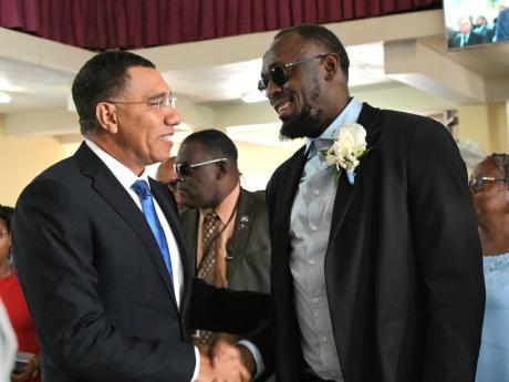 Prime Minister Dr Andrew Holness greeting sprint legend Usain Bolt at the funeral of Bolt’s father, Wellesley, at the Falmouth Seventh-day Adventist Church in Falmouth, Trelawny on May 5.