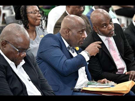 Alex Hepburn (second left), chairman of Quality Education Circle 11, speaks with Keven Jones (right), principal of Mona High School, and Wayne Robinson, principal of Jamaica College at the Quality Education Circle Town Hall forum held Friday at Jamaica Col
