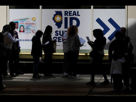 People line up to apply for Real ID at a Real ID Supercenter in downtown Chicago, Tuesday, May 6, 2025. (AP Photo/Kiichiro Sato)